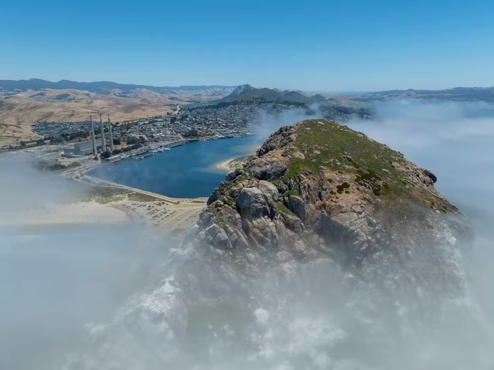 Aerial view of Morro Rock and Morro Bay with fog rolling in off the ocean